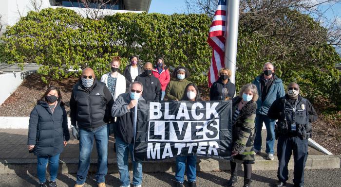 photo of a group of people holding the Black Lives Matter flag